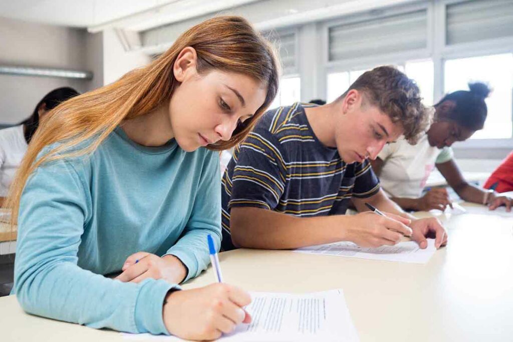 A group of students attentively taking a test in a classroom