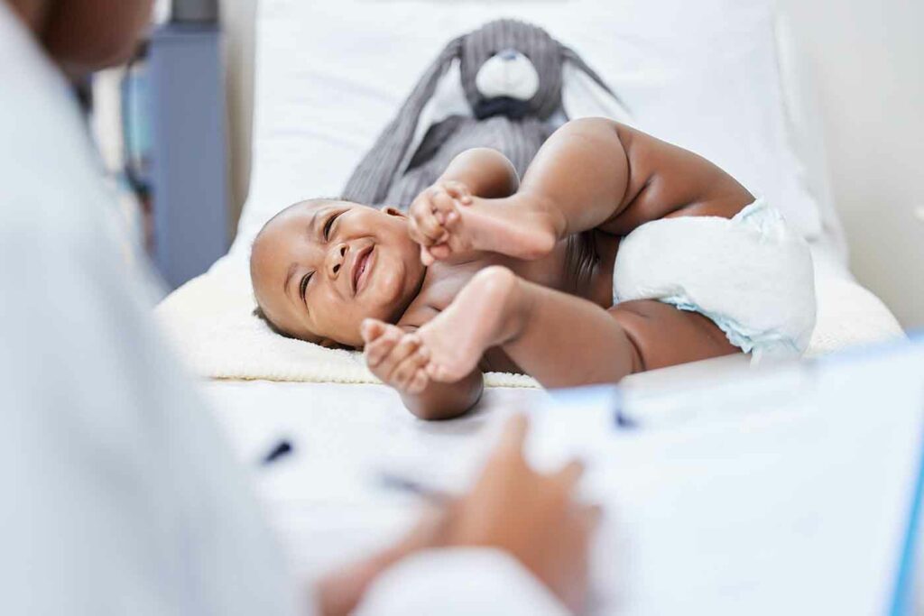 New Baby: A Guide 10 Shot of a doctor making notes about her infant patient on a clipboard.