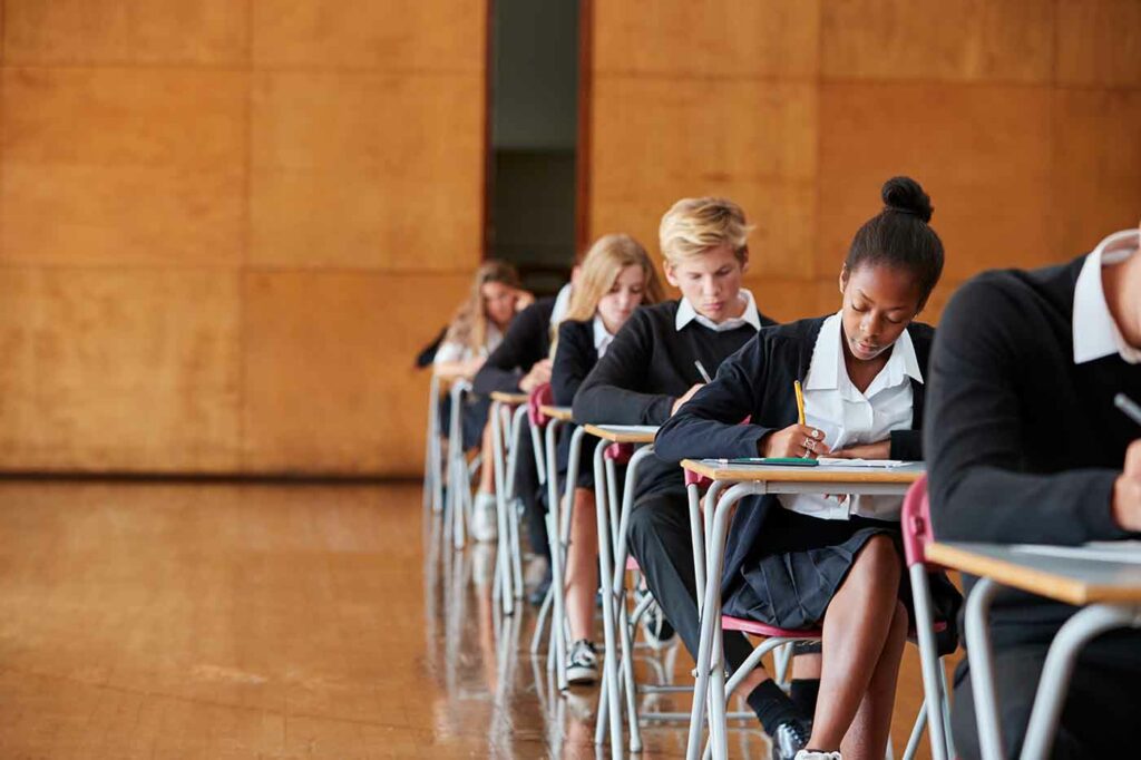 Exam Worries 1 teenage students in uniform sitting examination in 2023 11 27 05 33 48 utc